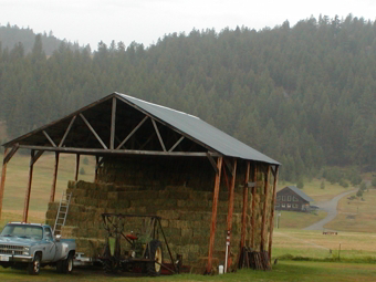 Hay stack with Eden Valley Lodge in background.